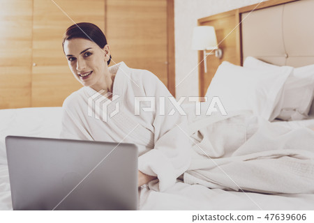 Pleasant woman resting in the bedroom Pleasant woman resting in the bedroom 47639606