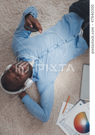 Positive happy man taking a break from work Positive happy man taking a break from work 47640300