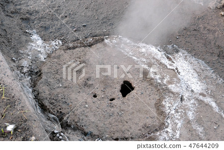 Steam is from sanitary sewer cover in snow on the roadside. Top view. Close-up. Steam is from sanitary sewer cover in snow on the roadside. Top view. Close-up. 47644209
