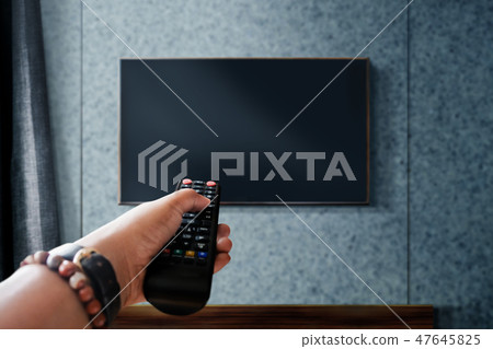 Watching Television Concept. Holding TV's Remote 47645825
