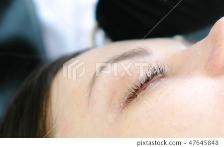 Closeup woman's lashes after procedure of Botox and lash lamination. Beauty treatment. Closeup eye. 47645848