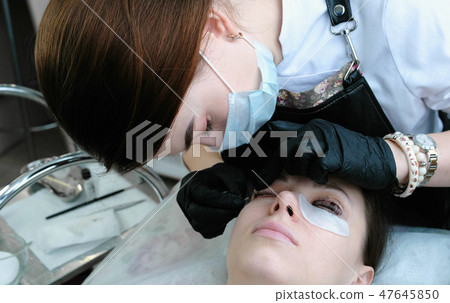 Beautician separates the lashes with a needle. Botox and lash lamination. Beauty treatment. 47645850