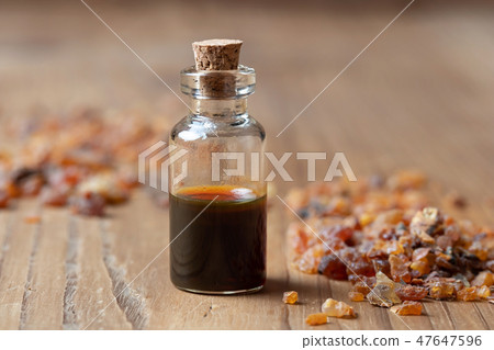 A bottle of myrrh essential oil with myrrh resin 47647596