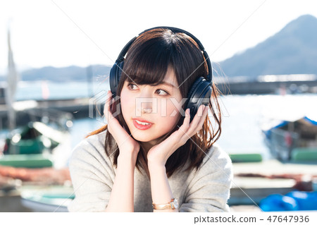 A young woman listening to music A young woman listening to music 47647936