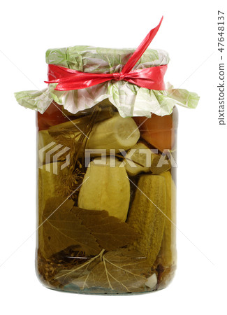 Pickled cucumbers in a glass jar 47648137
