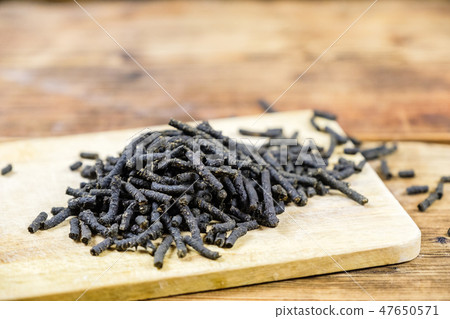 Close-up fermented Ivan-tea on wooden board. Dry herbal natural tea 47650571