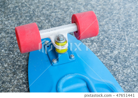Back of blue plastic skate board. Red wheels. 47651441