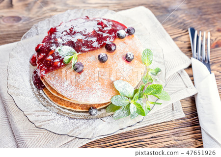Delicious and healthy breakfast of pancakes with berries, jam Delicious and healthy breakfast of pancakes with berries, jam 47651926