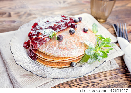 Delicious and healthy breakfast of pancakes with berries, jam Delicious and healthy breakfast of pancakes with berries, jam 47651927