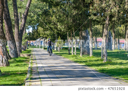 boy riding a bike in the park boy riding a bike in the park 47651928