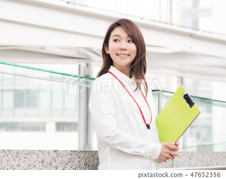 Businesswoman with yellow green file 47652356
