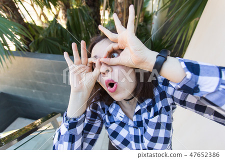Young woman made funny grimasse outdoor. April fools day celebration 47652386