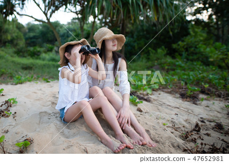 Mother and daughter playing with binoculars Mother and daughter playing with binoculars 47652981
