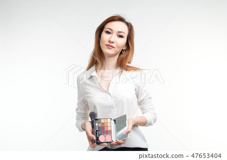Makeup artist, beauty and cosmetics concept - Korean female make-up artist with makeup brushes and Makeup artist, beauty and cosmetics concept - Korean female make-up artist with makeup brushes and 47653404