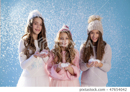 three fashionable girls in winter knitted hats snow winter three fashionable girls in winter knitted hats snow winter 47654042