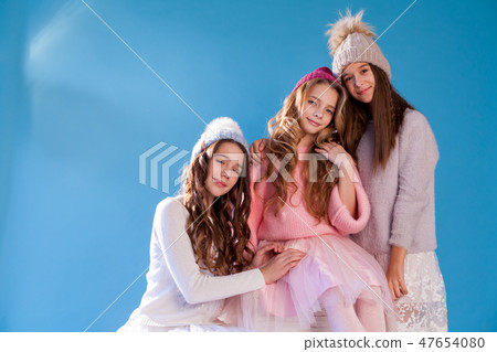three fashionable girls girlfriend in winter knitted hats 47654080