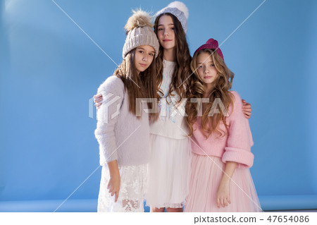three fashionable girls girlfriend in winter knitted hats 47654086