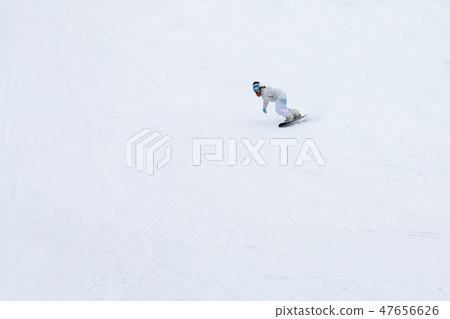 Female snowboarder rocking the slopes in winter Female snowboarder rocking the slopes in winter 47656626