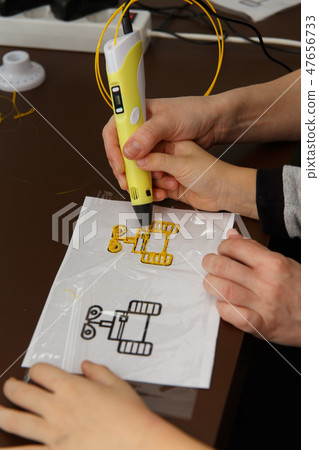 close up of 3D printing pen being used by kid. 47656733