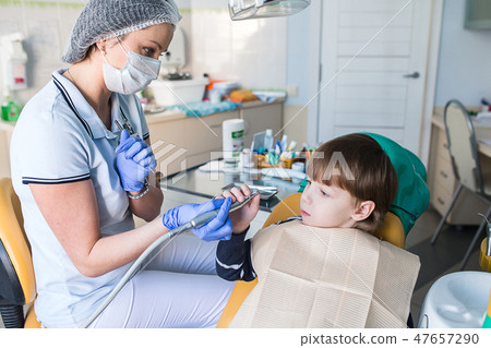 dentist shows the child instruments 47657290