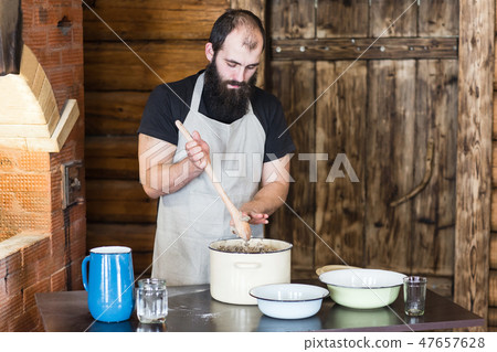 Men knead the dough for bread next to the wooden door and the rainforest 47657628