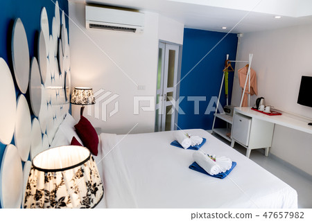 Luxury bed and pillow with light and wooden headboard. Luxury bed and pillow with light and wooden headboard. 47657982