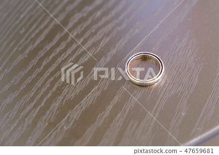 Wedding rings on dark wooden background. Top view. Wedding rings on dark wooden background. Top view. 47659681