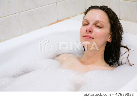young beautiful girl in a bath with foam young beautiful girl in a bath with foam 47659858