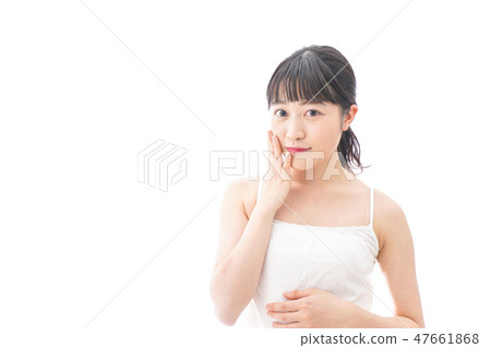 A young woman making skin care and makeup A young woman making skin care and makeup 47661868