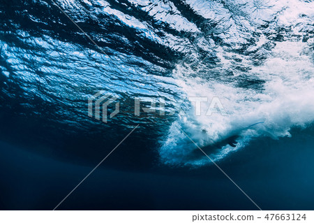 Barrel wave underwater with surfboard. Ocean 47663124