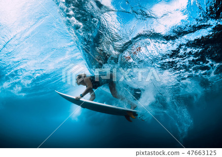 Surfer woman dive underwater. Surfgirl dive under 47663125