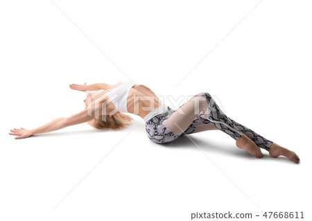 Seductive blonde woman in sportswear lying and stretching Seductive blonde woman in sportswear lying and stretching 47668611