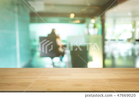 empty wooden desk over blurred coffee shop cafe background. 47669020