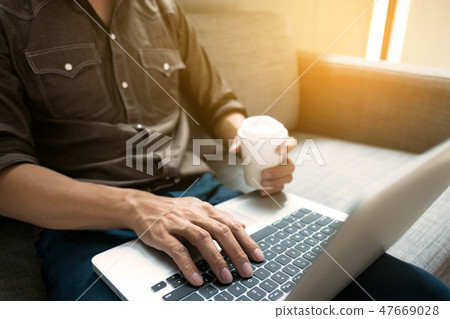 Business man in relax casual form working with laptop sitting on Business man in relax casual form working with laptop sitting on 47669028