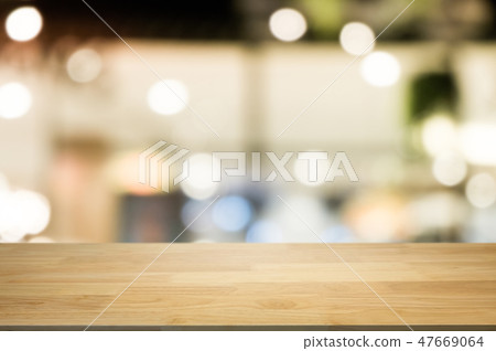 empty wooden desk over blurred coffee shop cafe background. 47669064