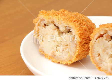 Cross section of beef croquette. Cross section of beef croquette. 47672759