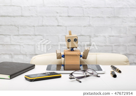 robot is sitting at the table robot is sitting at the table 47672954