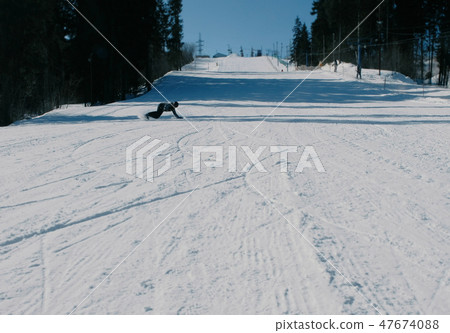Teenage boy of 12 years sliding on a snowboard from snow descent next sky lift. Teenage boy of 12 years sliding on a snowboard from snow descent next sky lift. 47674088