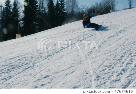 Man slides on a snowboard and ski from snow descent. Man slides on a snowboard and ski from snow descent. 47674619
