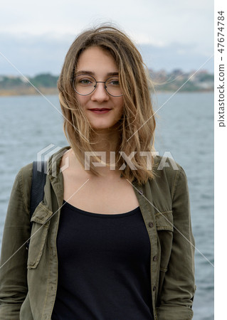 Portrait of a young girl with glasses Portrait of a young girl with glasses 47674784