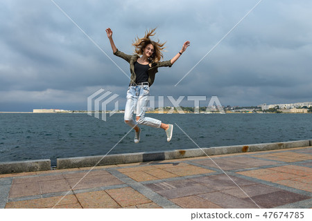 A young girl taken in a jump A young girl taken in a jump 47674785