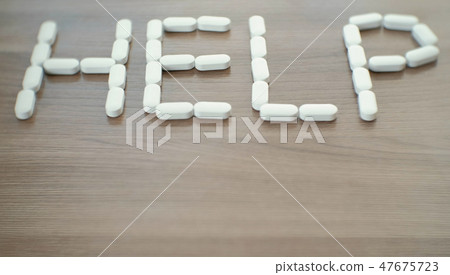 word - help consists of pills on the table. word - help consists of pills on the table. 47675723