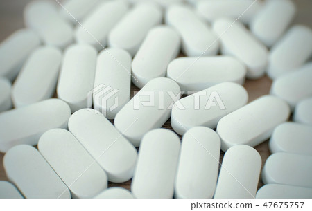 White pills on the table. White pills on the table. 47675757