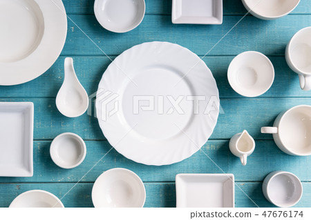 Various empty white plates and bowls 47676174