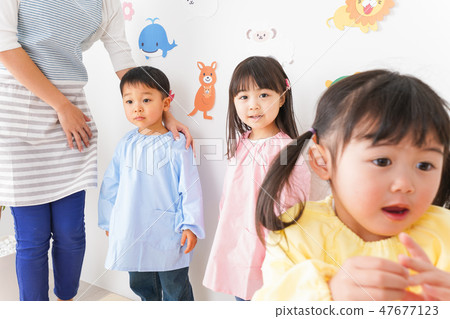 Kindergarten teachers and children 47677123