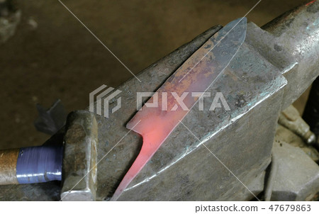Making the knife out of metal at the forge. Top view. 47679863