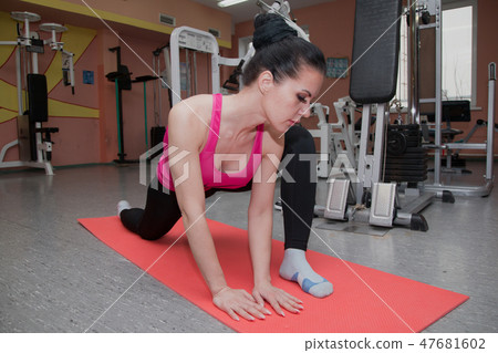 Beautiful girl is exercising in the fitness club 47681602