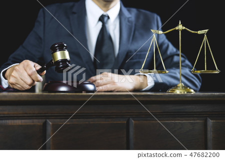 Counselor or Male lawyer working on courtroom sitting at the tab Counselor or Male lawyer working on courtroom sitting at the tab 47682200