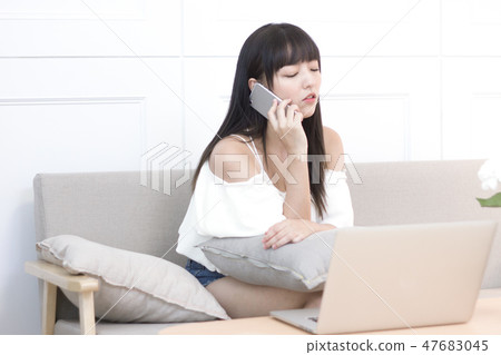 Beauty using a mobile phone and a laptop 47683045