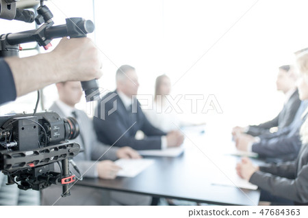Videographer making video of business people 47684363